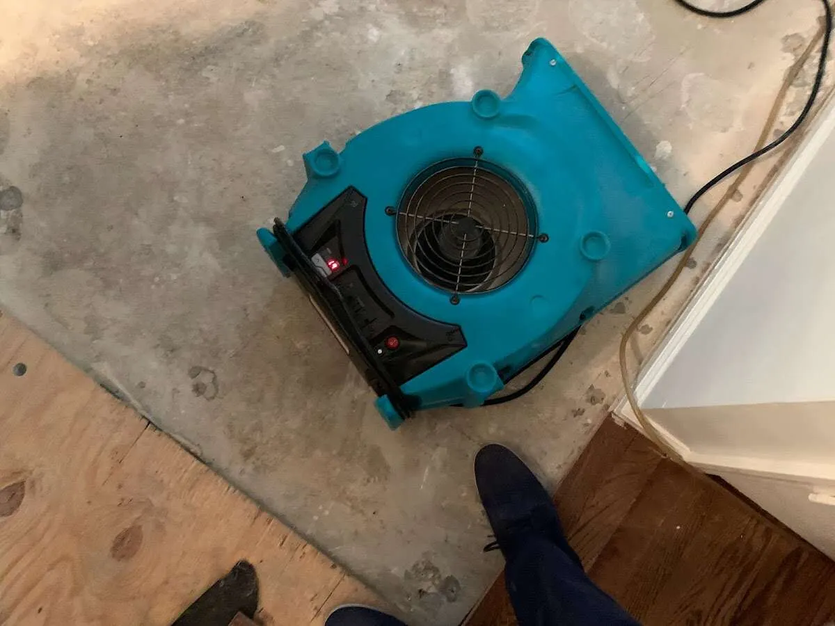Air mover drying subfloor during Commercial Water Damage Restoration in Ranchettes